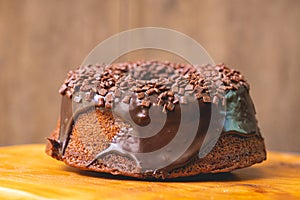 Chocolate cake with creamy chocolate sauce and decorated with chocolate sprinkles. photo