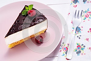 Chocolate cake with decoration and fruits in a plate with fork
