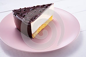 Chocolate cake with decoration and fruits in a plate on wooden background