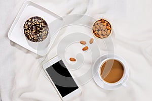 Chocolate cake donuts with a cup of coffee on marble table top