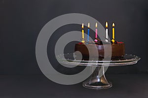 chocolate cake with five colorful candeles. Birthday cake with candel light