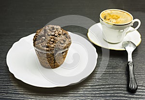 Chocolate cake Muffin on a white plate and a cup of coffee.