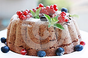 Chocolate cake with nuts decorated with fruits