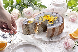 Chocolate cake with orange and icing. On a white background, and a bouquet of white roses. Good morning with a surprise and