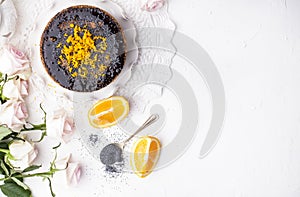 Chocolate cake with orange and icing. On a white background, and a bouquet of white roses. Good morning with a surprise and