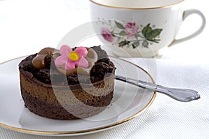 Chocolate Cake with Pink Flower on Top White Background