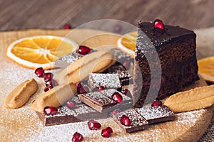 Chocolate cake with pomegranate, bitter chocolate and biscuits.