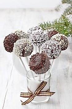 Chocolate cake pops decorated with nuts and shredded desiccated coconut