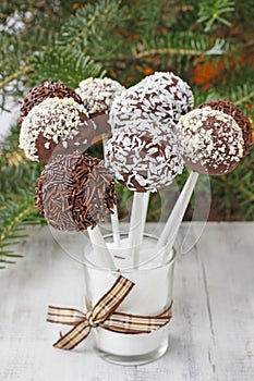 Chocolate cake pops decorated with nuts and shredded desiccated coconut