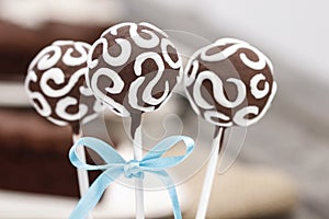 Chocolate cake pops decorated with white icing