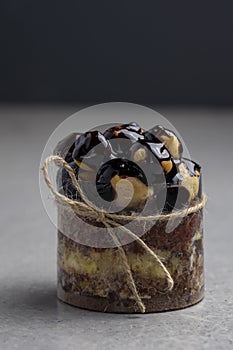 Chocolate cake with profiteroles on a gray background.