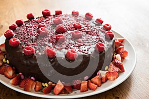 Chocolate cake with raspberries and strawberries slices