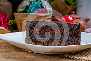 Chocolate cake with red cherry
