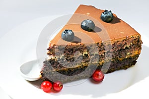 Chocolate Cake with a red currant and a blackberry