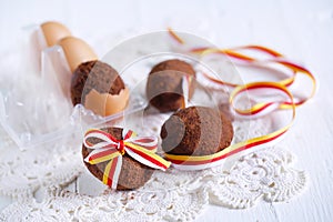 Chocolate cake in the shape of easter egg tied with ribbon