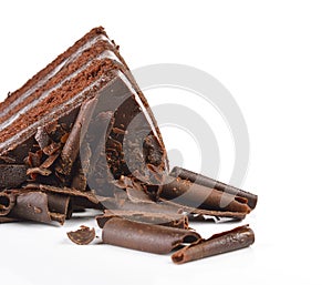 Chocolate cake slice with curl on white background.