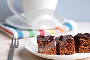 Chocolate cake squares with jam, teatime photo