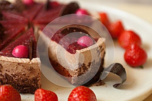 chocolate cake with strawberries close up. slice with chocolate drips and souffle. Confectionery