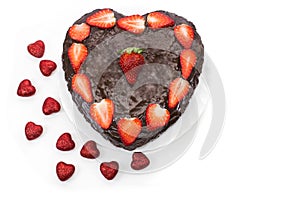 Chocolate cake with strawberries on a white background.