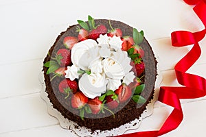 Chocolate cake with strawberries, white board with copy space, red ribbon