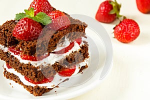 Chocolate cake with strawberry and cream.