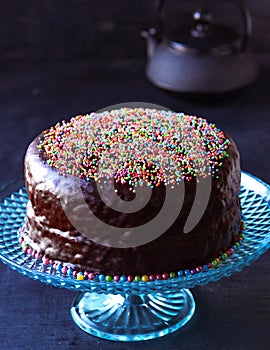 Chocolate cake with tea pot at tea time