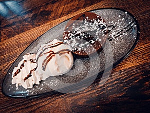Chocolate cake with vanila icecream in a fancy plate photo