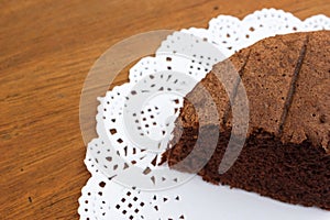 Chocolate cake on white Doyley Paper.