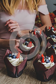 Chocolate cakes with berries on the cream