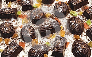 Chocolate candies, candied fruits on a light background