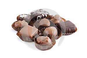 Chocolate candies in a candy wrapper on a white background. A set of sweets with different tastes ..