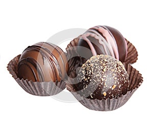 Chocolate candies. Collection of beautiful Belgian truffles in wrapper isolated