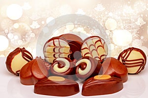 Chocolate candies collection. Beautifully assortment of various swizz chocolate candies sweets on table over abstract bright