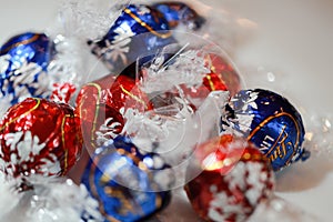 Chocolate candies Lindt Lindor. Candy in multi-colored wraps. Illustrative editorial