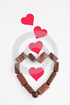 Chocolate candies shape heart valentines background white cardboard