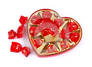 Chocolate candy in a heart-shaped box for Valentine`s Day on a white background