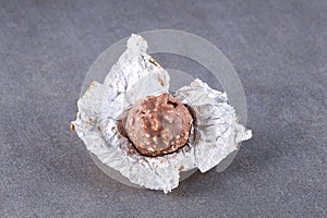 Chocolate candy in its open wrap on a slate board with copy space for your text