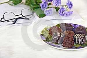 Chocolate candy on plate with white fur