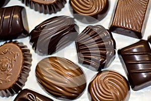 Chocolate candy of various shapes with different fillings.