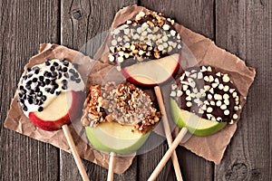 Chocolate and caramel dipped apple rounds, above on rustic wood