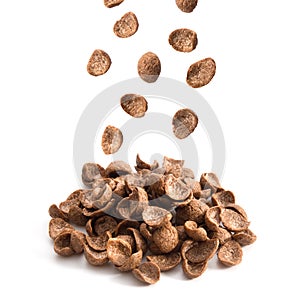 Chocolate cereals falling isolated on white background