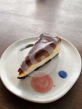 Chocolate cheese cake on white plate