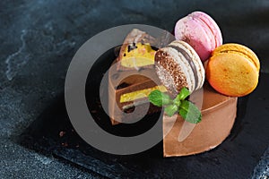 Chocolate cheesecake with banana filling decorated with macarons and toffee