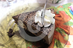 Chocolate cheesecake decorated with white cream flower and chocolate leaf