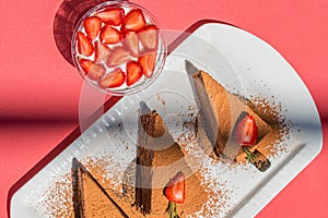 Chocolate cheesecakes with strawberries on pink abstract backgrount.