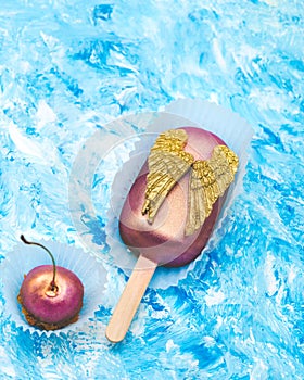 Chocolate Cherry. Cake pop with chocolate decorative golden wings