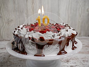 Chocolate cherry cake with ten candle for celebration