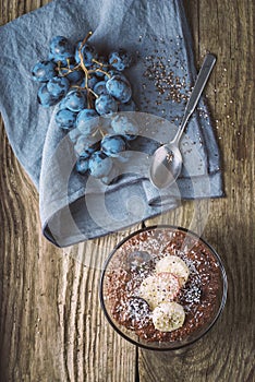 Chocolate chia pudding with fruit in the glass bowl top view