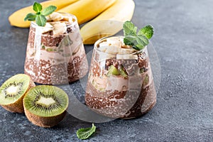 Chocolate chia pudding with fruits in a glass in almond milk. Healthy food