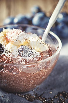 Chocolate chia pudding with fruits in the glass bowl